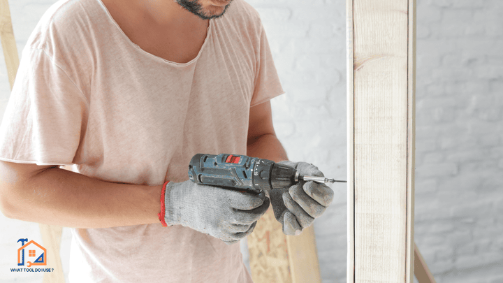 person drilling into plasterboard