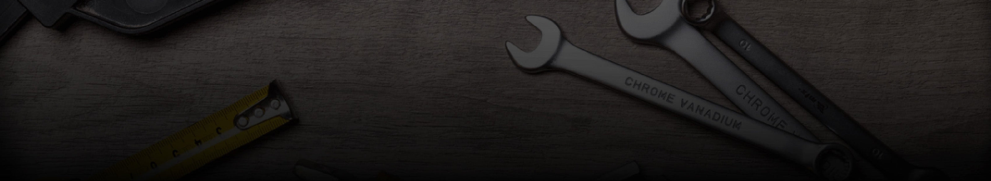 Wrenches and pliers on a wooden surface